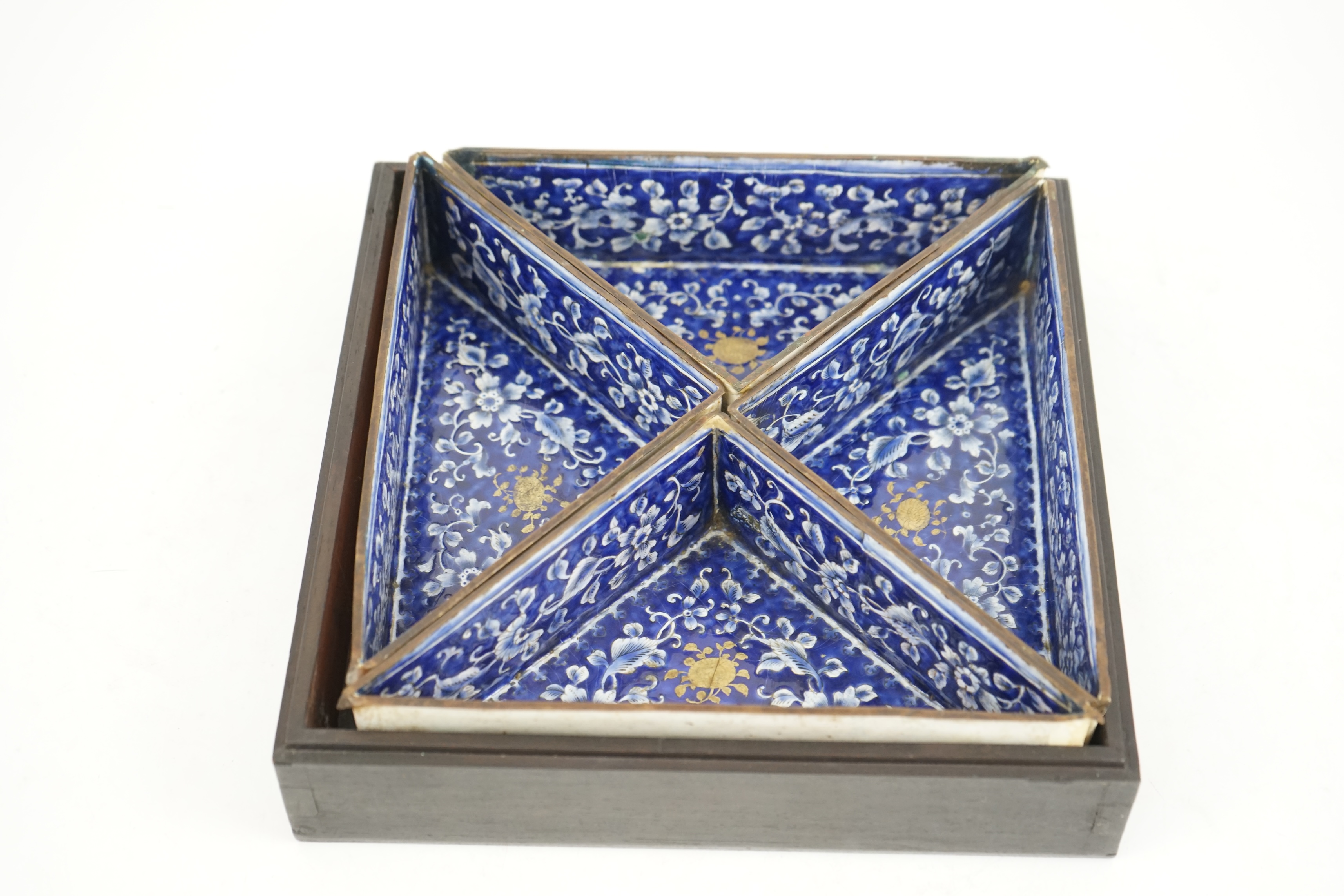 Four triangular 19th century Chinese Canton enamel sectional dishes, later boxed, 24cm wide overall. Condition - some restoration